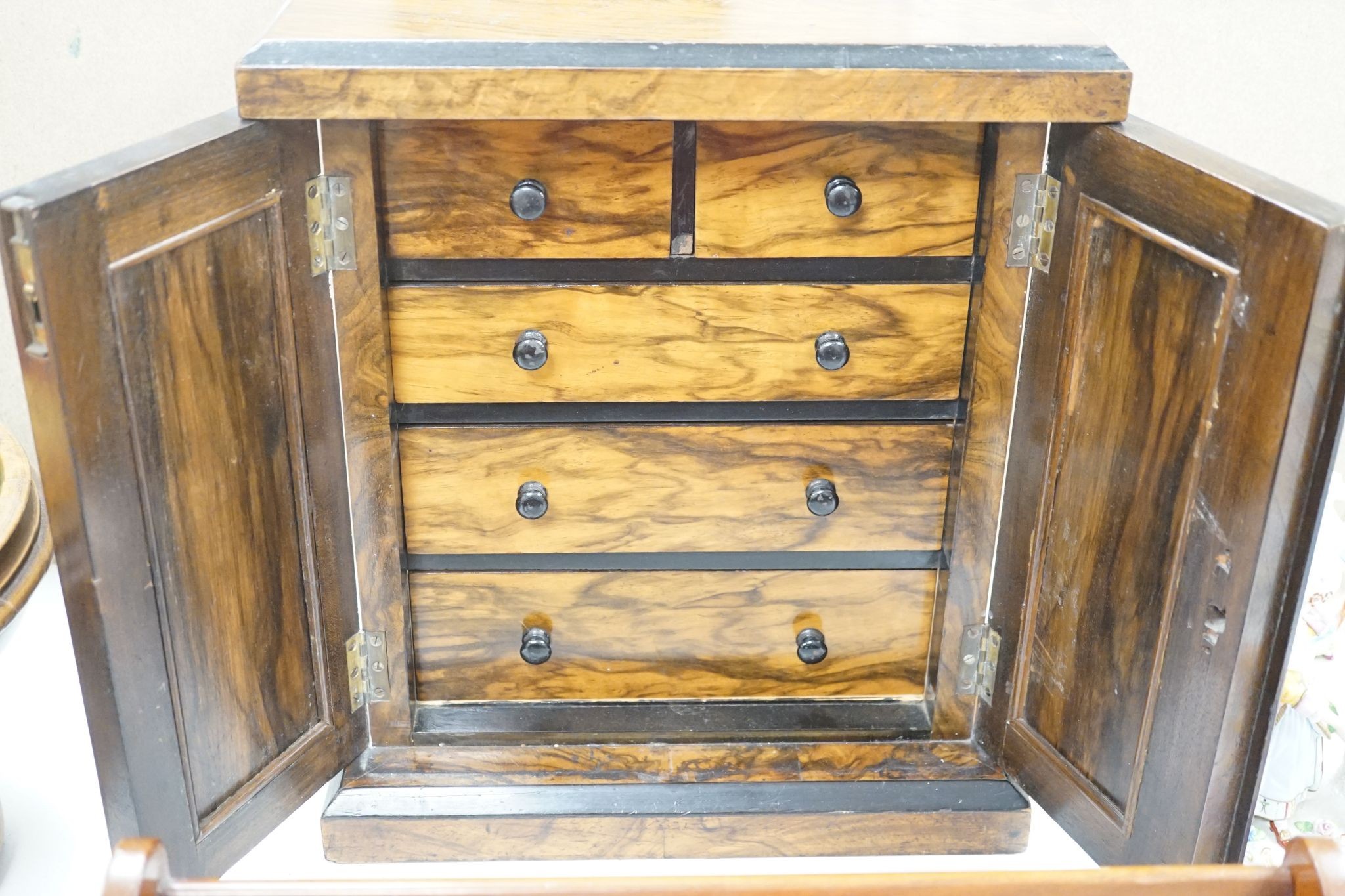 A Victorian walnut collector’s cabinet of drawers and adjustable book trough made out of ‘mahogany from the popular pleasure steamer “La Marguerite” dismantled 1926’